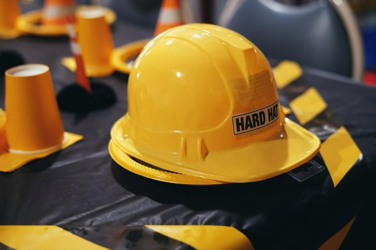 Yellow hard-hat party prop on a construction-themed party table