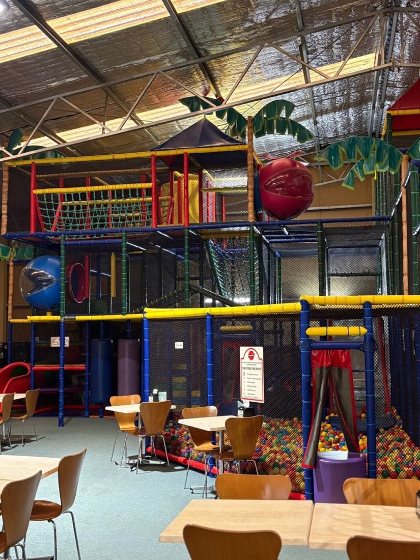 Looking up at the three-storey play structure from the café floor at Rumble Tumbles
